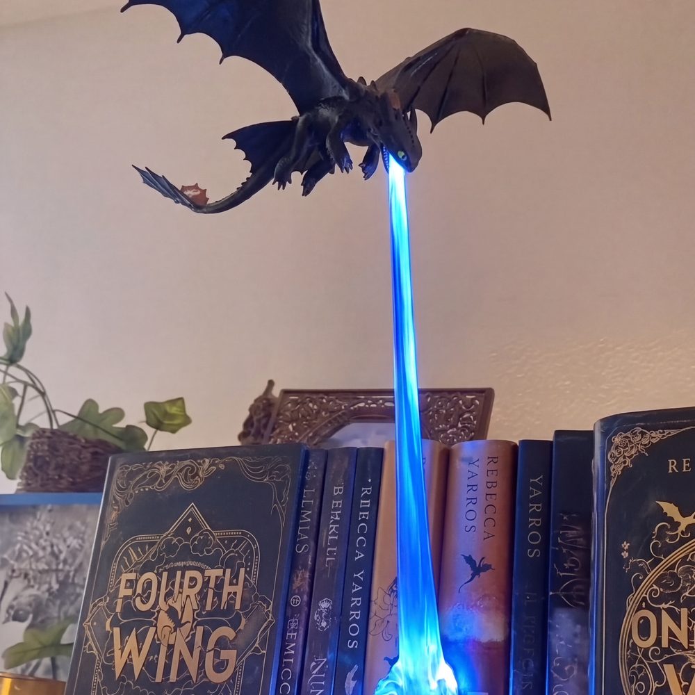 The blast landing across the book spines